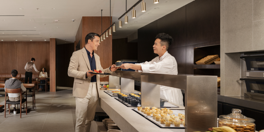 A Cathay Pacific Airport Services Agent assisting a passenger at Hong Kong International Airport 